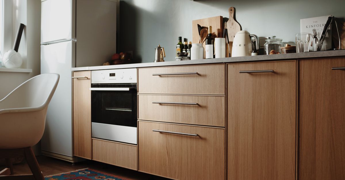 Beautiful modern kitchen featuring sleek wooden cabinets and appliances.